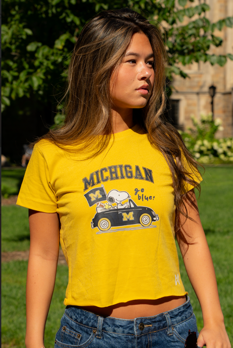 Person wearing a yellow 'Michigan' t-shirt with a SNOOPY and MITTN.